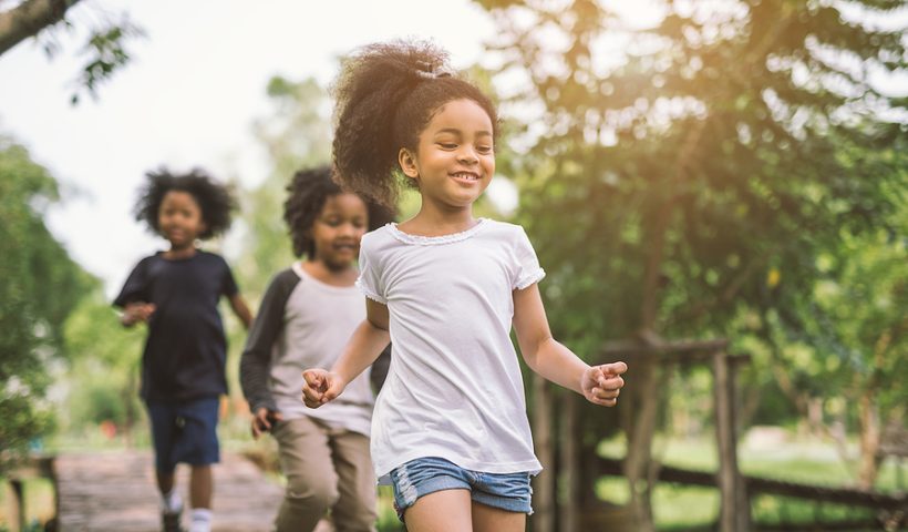 Cute African American little girl playing outdoors