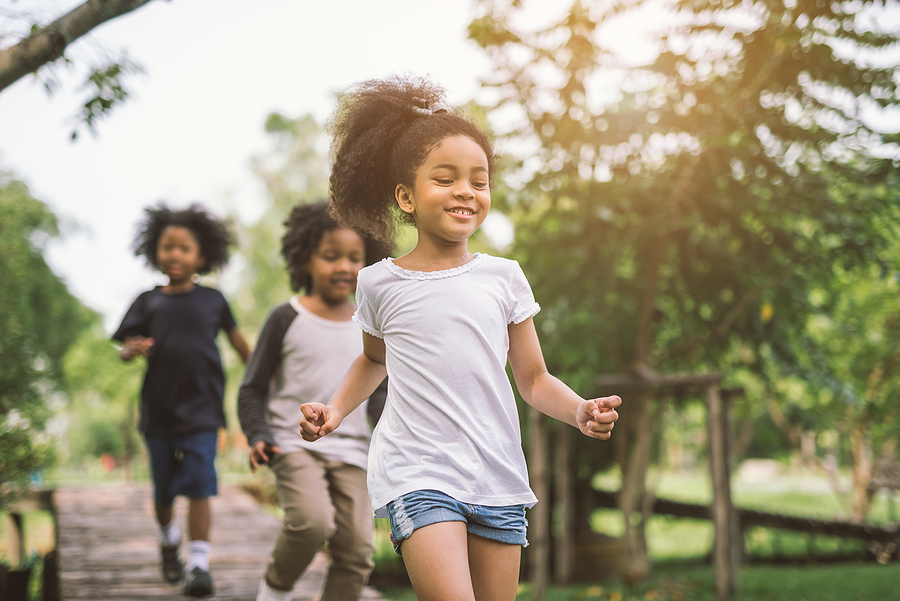 Cute African American little girl playing outdoors