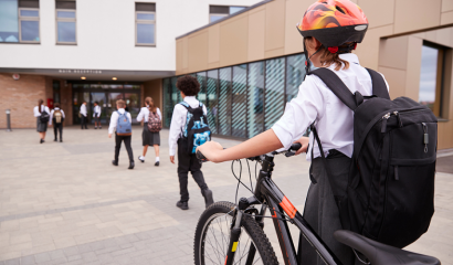 A group of teenagers head toward the front doors of their private school.